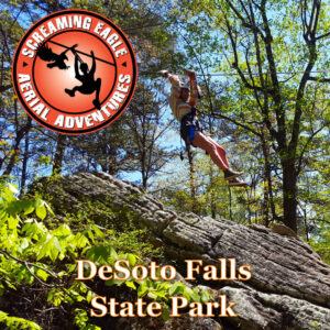 person on a zip line above the trees at DeSoto Falls State Park